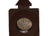a brown lantern that is hanging on a white wall