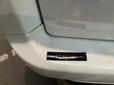 a sticker on the bumper of a white car