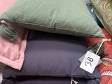 a pile of pillows on a table with a price tag on it