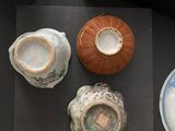 many different types of pottery on the table