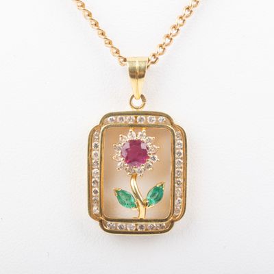 a close up of a necklace with a flower on it