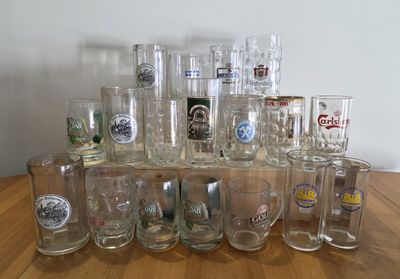 a lot of glasses sitting on a wooden table