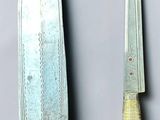 two knives that are next to each other on a table