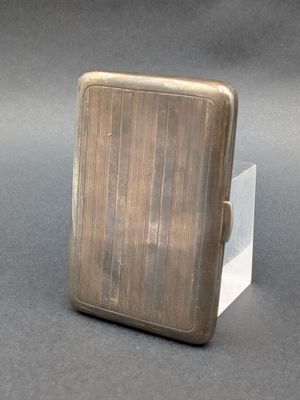 a small silver cigarette case sitting on a table