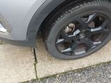 a close up of a car ' s tire on the street