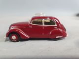 a red toy car sitting on a table next to another toy car