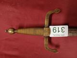 a close up of a sword on a red surface with a price tag