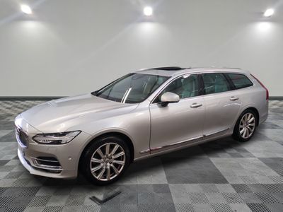 a silver volvo wagon parked on a checkered tile floor