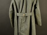 an image of a coat on a mannequin stand against a black background