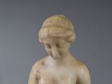 a statue of a woman holding a bowl of fruit