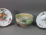 three plates and a bowl are sitting on a table