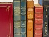 books are lined up in a row on a white surface