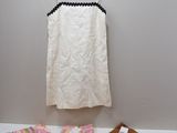 a white top and brown shorts on a hanger