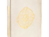 a white book with a gold design on the cover