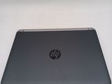 the back of a laptop computer sitting on top of a white table