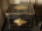 a black and gold box sitting on top of a black table