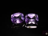 pair of purple amethorate earrings on black background