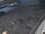 a black car parked on the side of the street