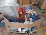 a cardboard box full of clothes and other items