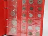 a red folder with coins inside of it on a white surface