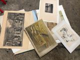 a pile of old photographs on the floor next to a pair of pliers