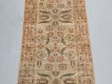 un tapis ancien au motif allongé et étroit posé sur un sol blanc