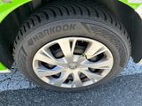 a close up of a tire on a green car
