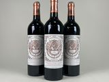trois bouteilles de vin rouge posées sur une table