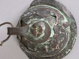 a close up of a metal object on a white surface