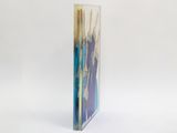 a tall glass vase with a blue and purple design on it