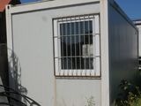 an image of a small white building with a window and hoses
