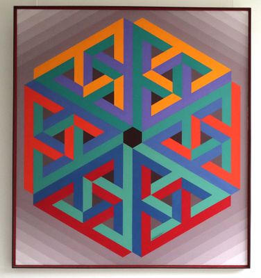 tableau représentant un motif géométrique multicolore accroché à un mur