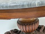 a marble top table with a wooden base and a marble top