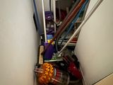 an image of a small room with a vacuum and mop
