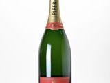 a close up of a bottle of champagne on a white surface