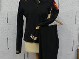 a mannequin with a uniform on it next to a wall