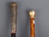two baseball bats that are sitting next to each other