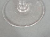 two wine glasses sitting on a table next to each other