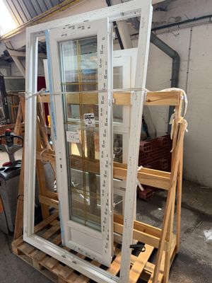 une grande fenêtre posée sur une palette dans un garage