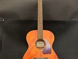 a wooden guitar sitting on top of a metal stand