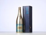 bottles of champagne and a blue box on a white surface