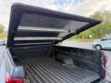 a pickup truck with its bed open in a parking lot