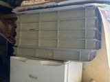 a refrigerator and a freezer in a small room