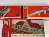 two boxed model trains are sitting on a table next to each other