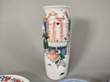 a white vase with a design on it sitting on a table
