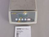 the electronic scale is sitting on the table next to the manual