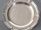 a silver plate on a table with a fork and knife