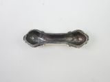 a small metal object on a white surface