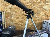 a telescope that is sitting on a table next to a box