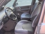 the interior of a car with the door open and the driver ' s seat down